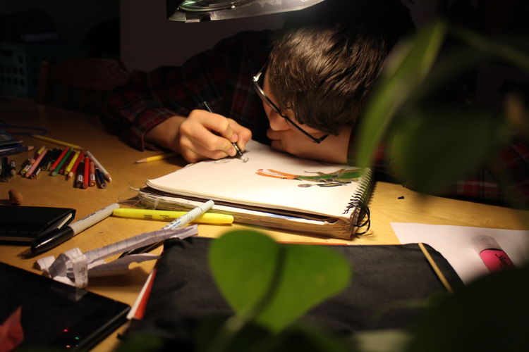 High angle view of boy drawing at home