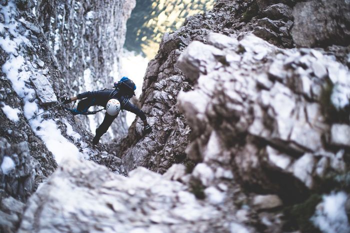 High angle view of man climbing rock