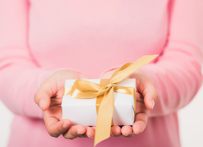 Midsection of woman holding gift