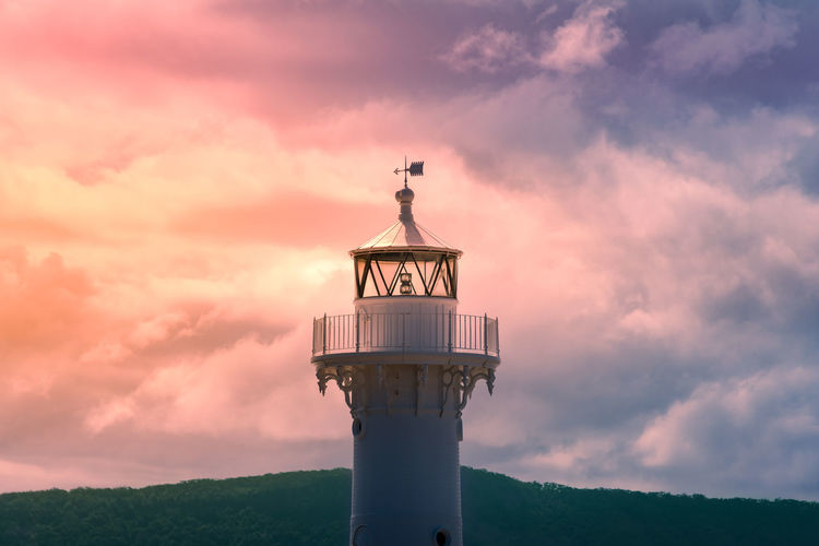 Lighthouse against sky during sunset