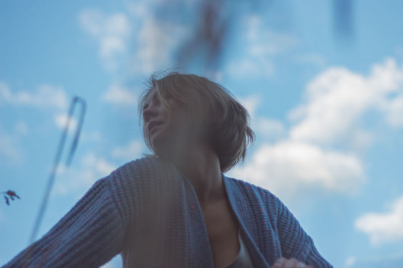 Low angle view of woman dancing against sky