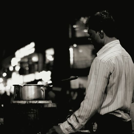 Vendor making tea at concession stand in city