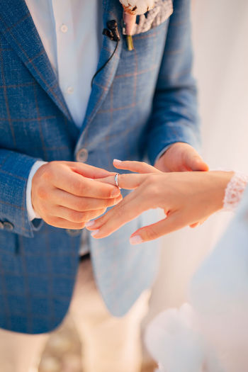 Midsection of couple holding hands