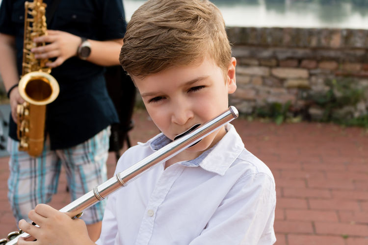Close-up of boy playing flute