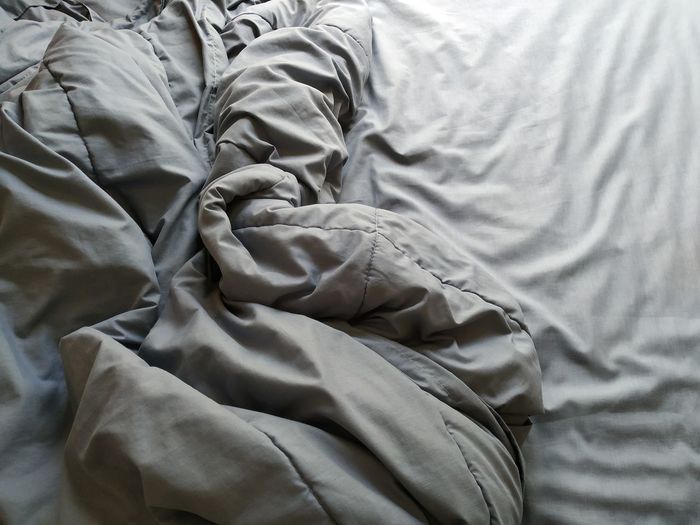 High angle view of crumpled blanket on bed at home