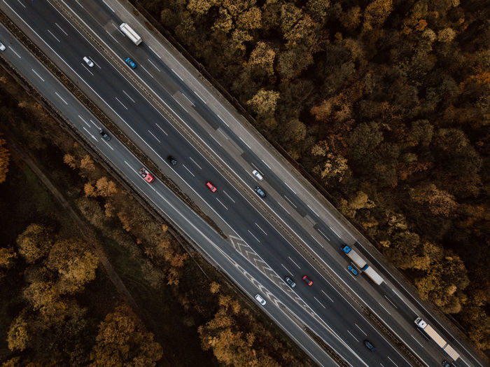 High angle view of cars moving on road amidst trees