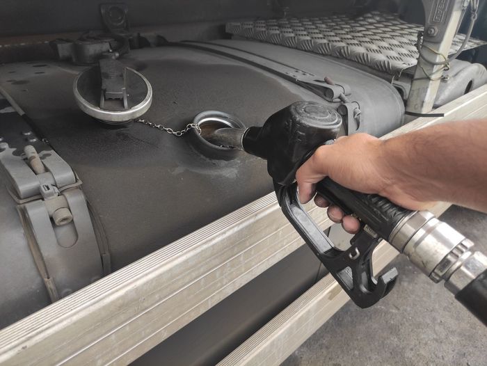 Cropped hand of man refuelling a truck