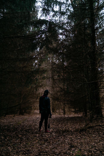 Full length of woman walking in forest