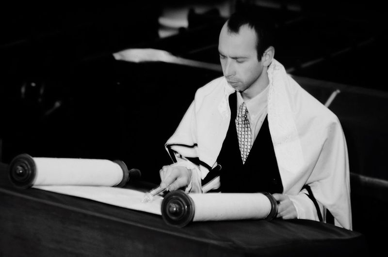 Close-up of a man reading torah