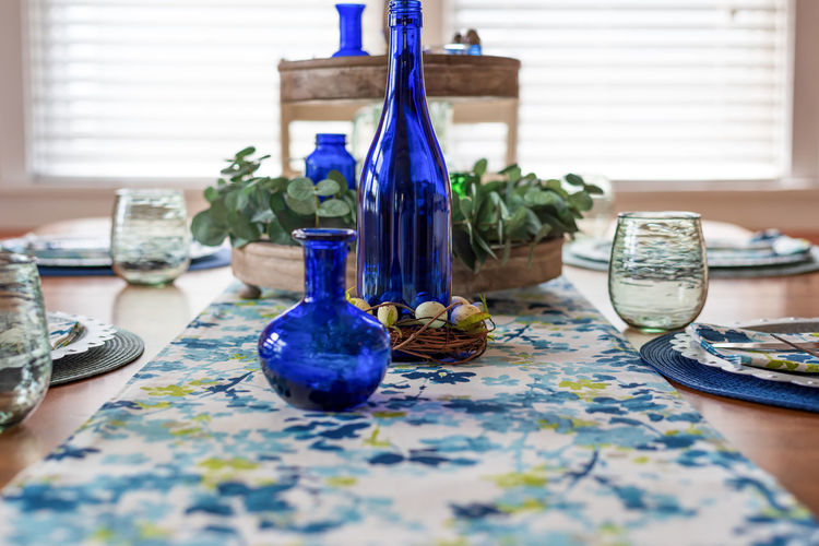 Closeup of dinner table with pretty blue and green decor