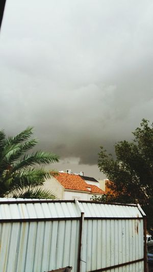 Houses against cloudy sky
