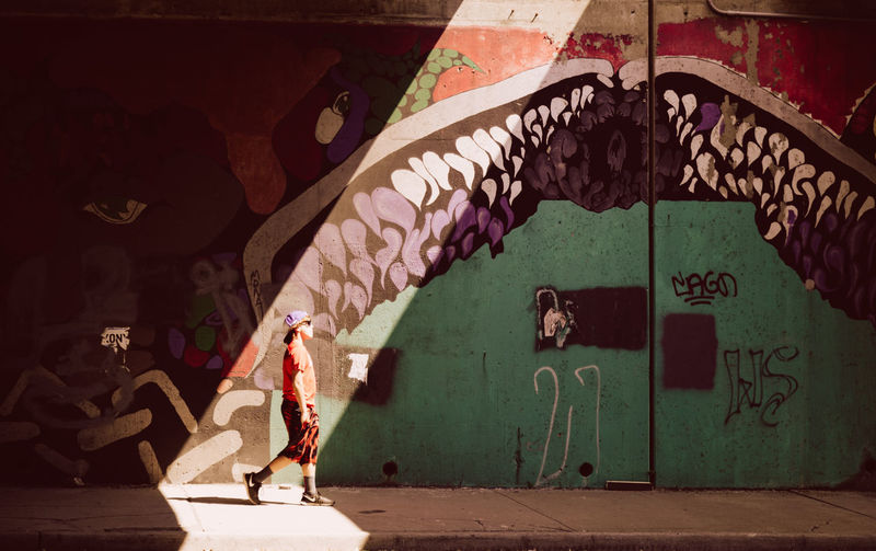 Woman standing by wall