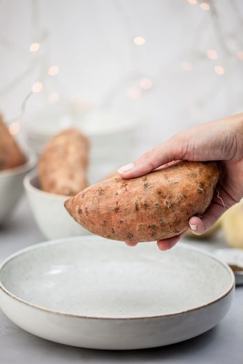 Close-up of hand holding sweet potato