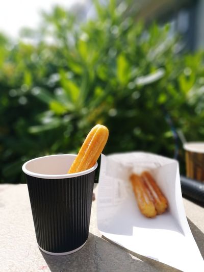 Close-up of churros in cup served on table