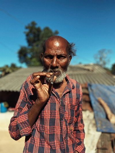 Portrait of an indian man smoking cigar