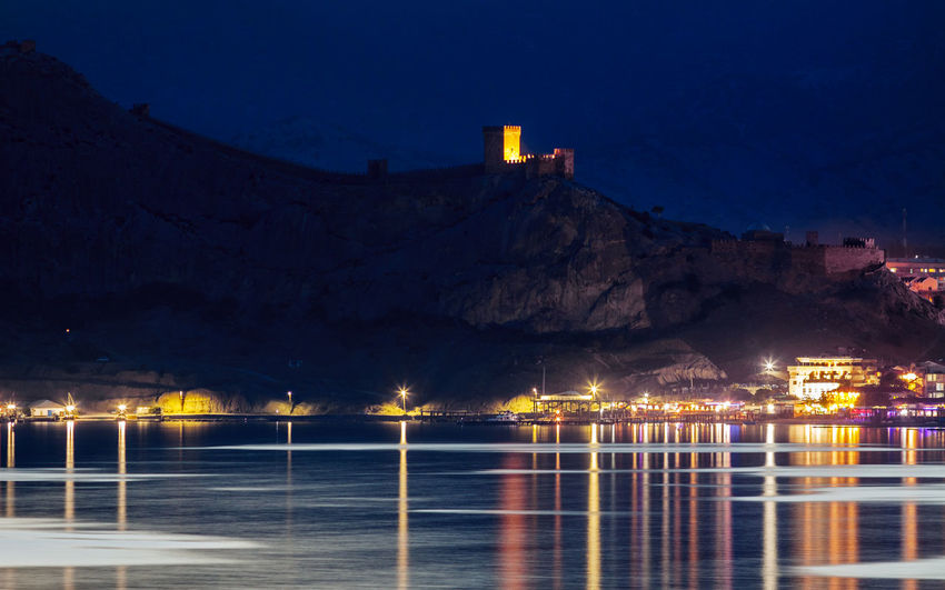 Night view of genoese fortress from water in crimea