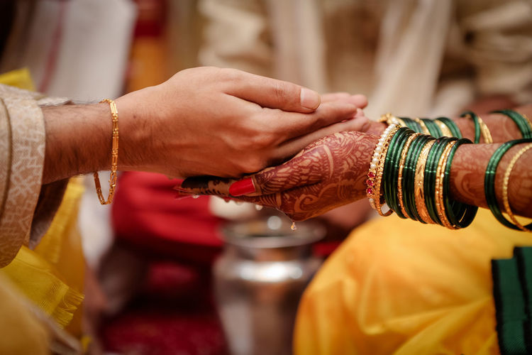 Cropped hands of couple during wedding ceremony