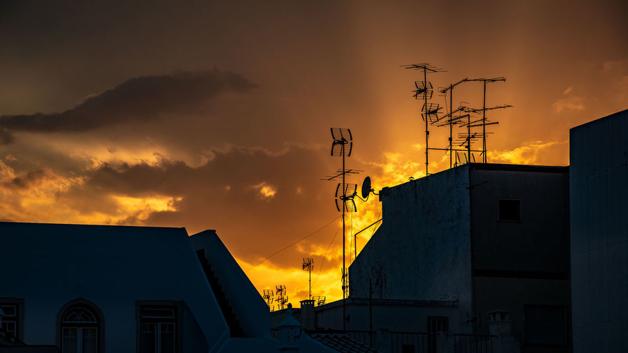 Low angle view of silhouette buildings against sky during sunset