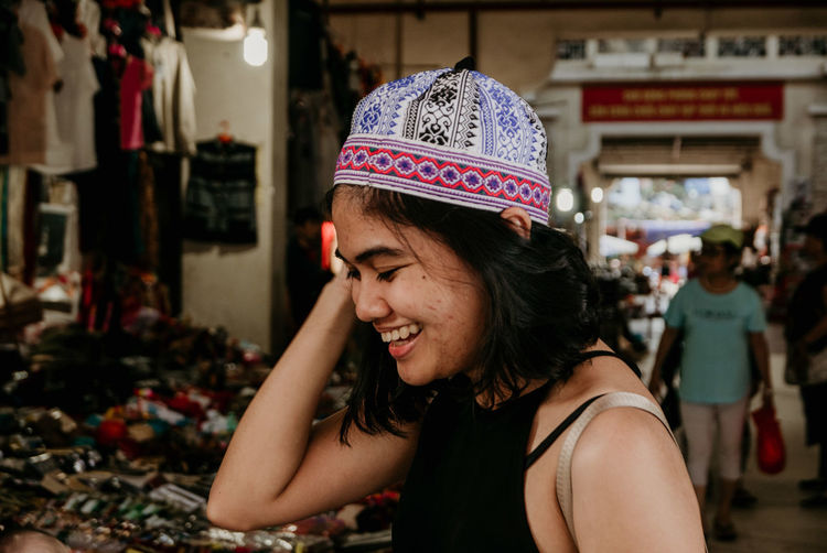 Smiling young woman standing in market