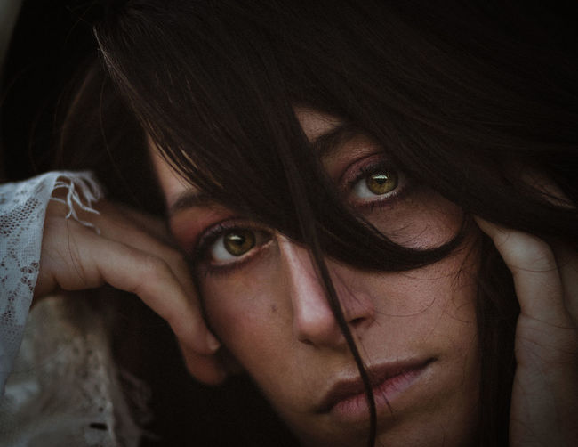 Close-up portrait of young woman with brown eyes