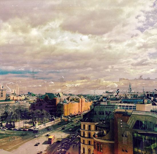 Cityscape against cloudy sky