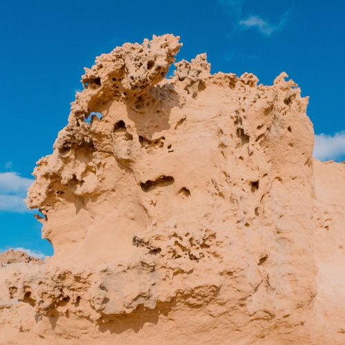 Low angle view of rock formation against sky
