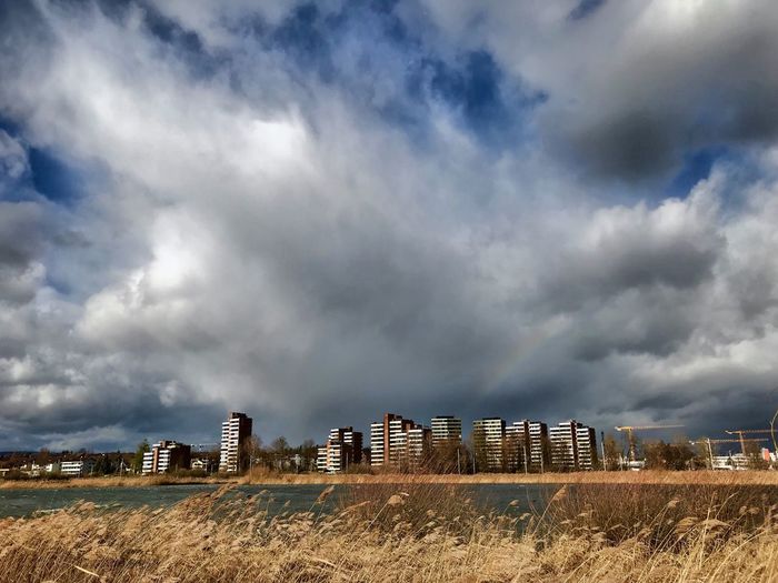 Storm clouds over field in city