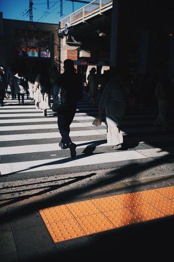 People crossing road in city