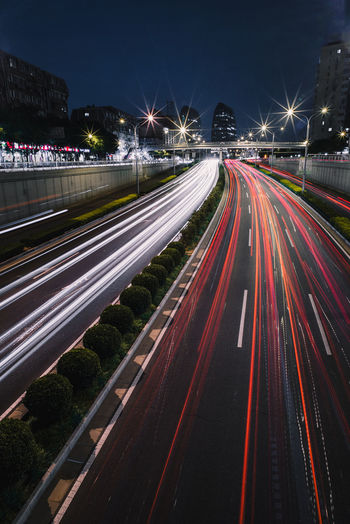 High angle view of light trails on multiple lane highway at night