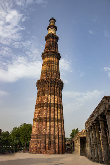 Low angle view of historical building qutab minar against sky