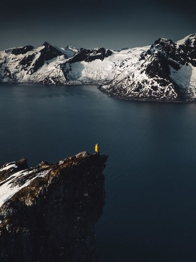 Scenic view of lake and snowcapped mountain against clear sky