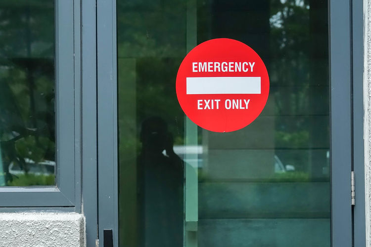 Emergency exit sign on closed glass door