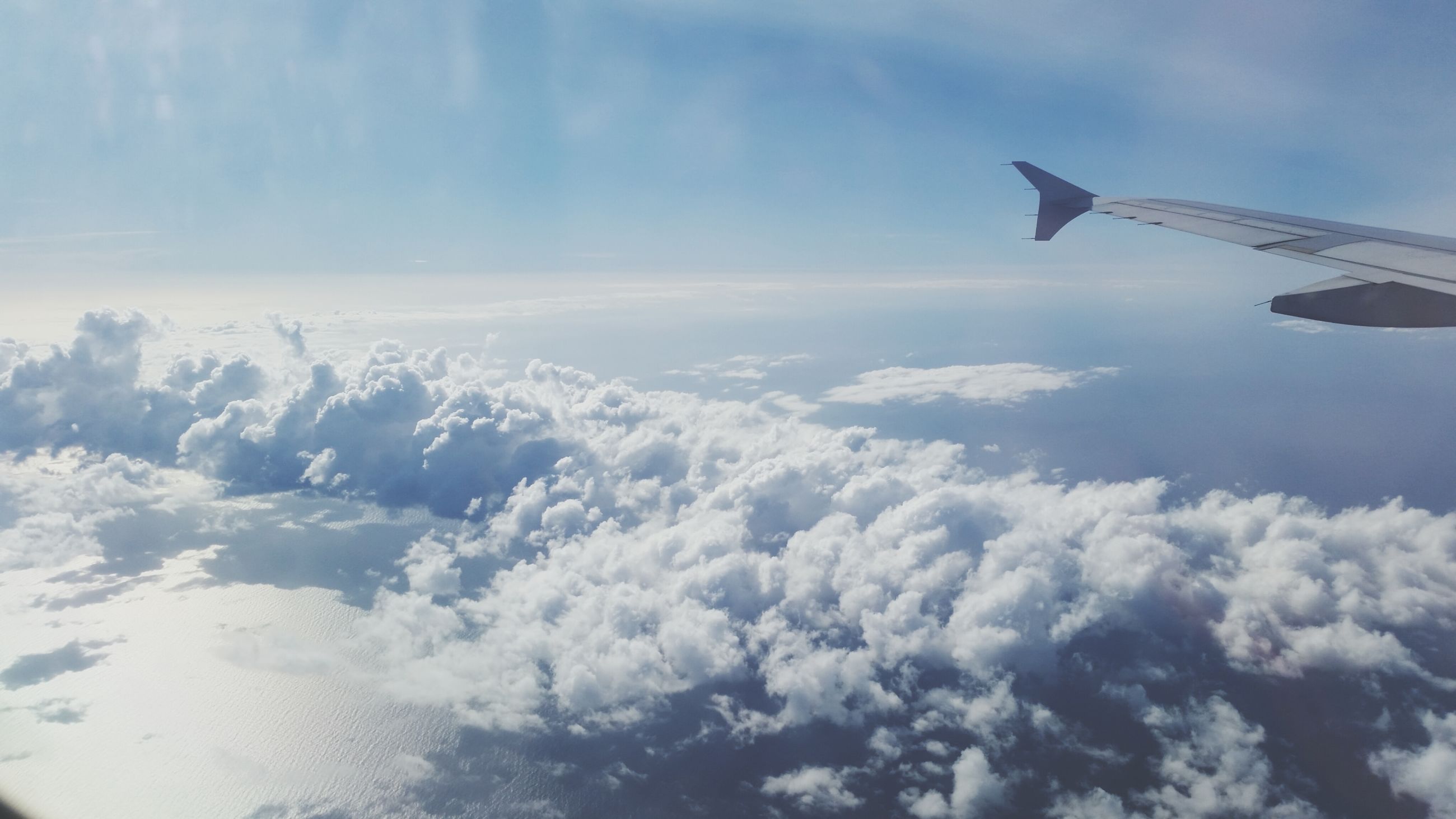 airplane, aircraft wing, air vehicle, flying, aerial view, sky, transportation, part of, cropped, mode of transport, cloud - sky, scenics, mid-air, beauty in nature, travel, nature, cloud, journey, tranquil scene, cloudscape