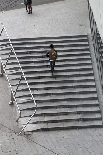 High angle view of man walking up steps