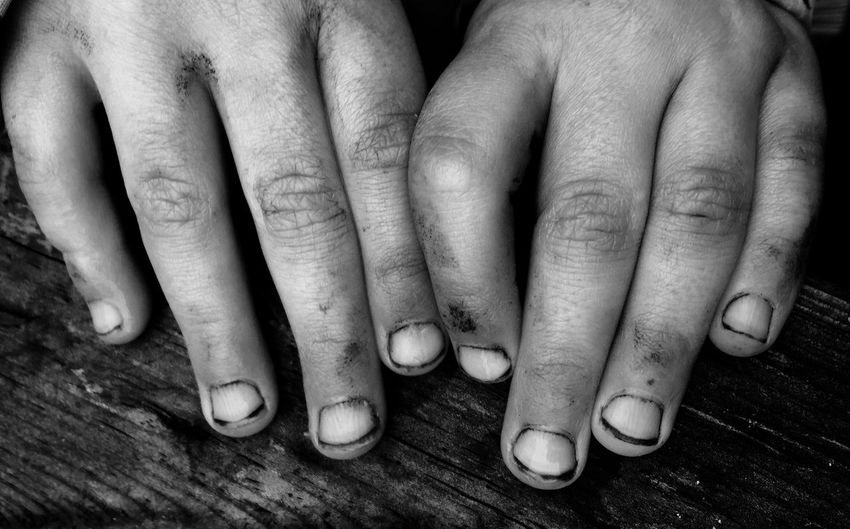 Cropped image of dirty hands on wood