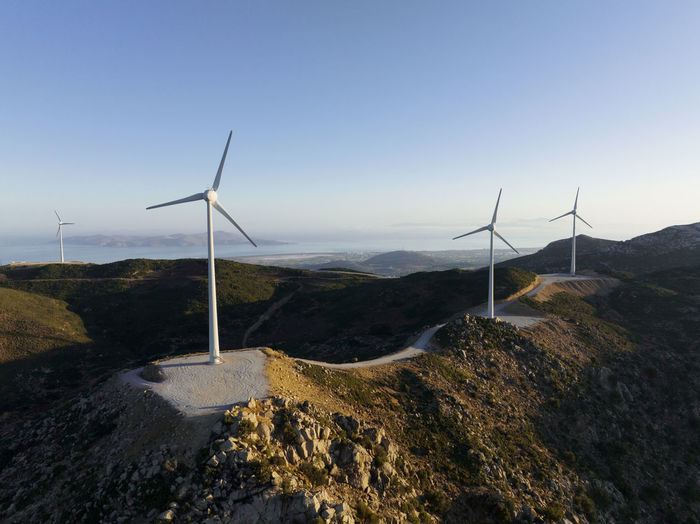 Greece, aegean, kos, wind farm turbines at dawn