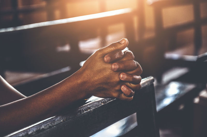 Close-up of hands clasped