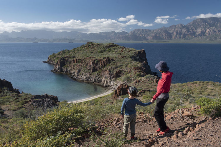A woman and her son on a hill at del carmen island in loreto bay