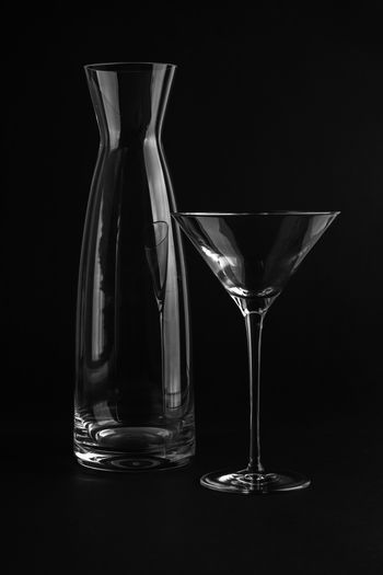 Close-up of beer glass on table against black background
