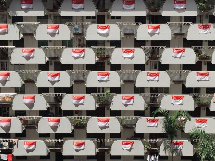 Full frame shot of singaporean flags on building balconies