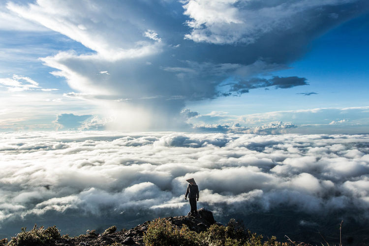 Man standing against cloudscape