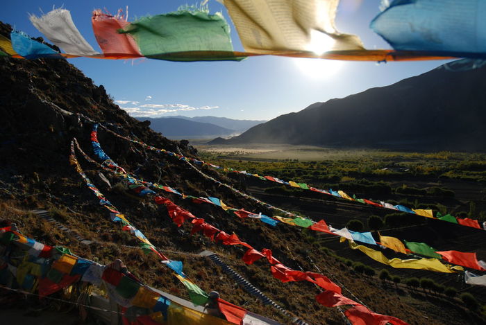 Colorful prayer flags hanging over mountains