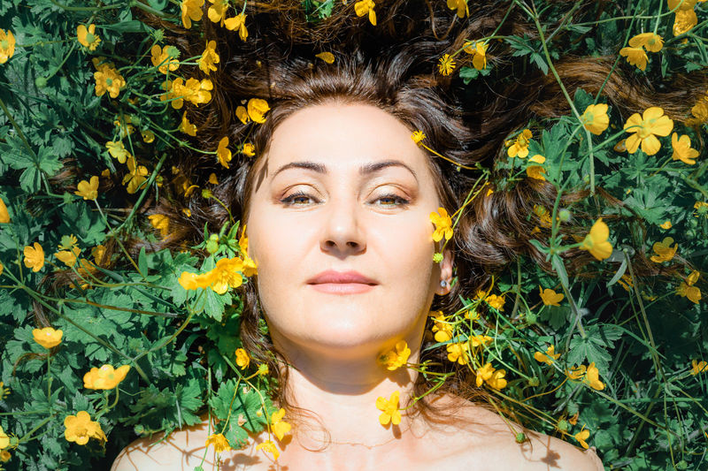 Portrait of young woman by plants