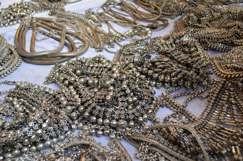 High angle view of antique jewelry for sale at market stall