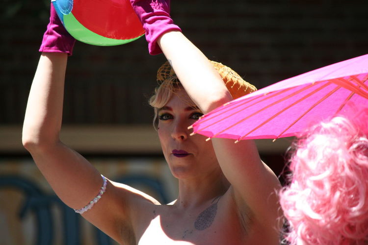 Woman holding ball during gay pride parade