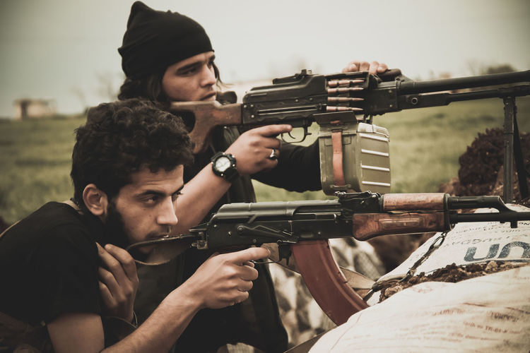Rebels using rifle during war