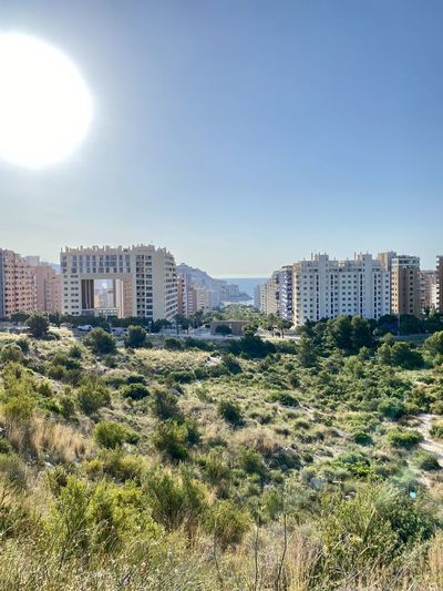 Buildings in city against clear sky