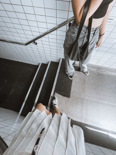 Low section of woman standing on tiled floor