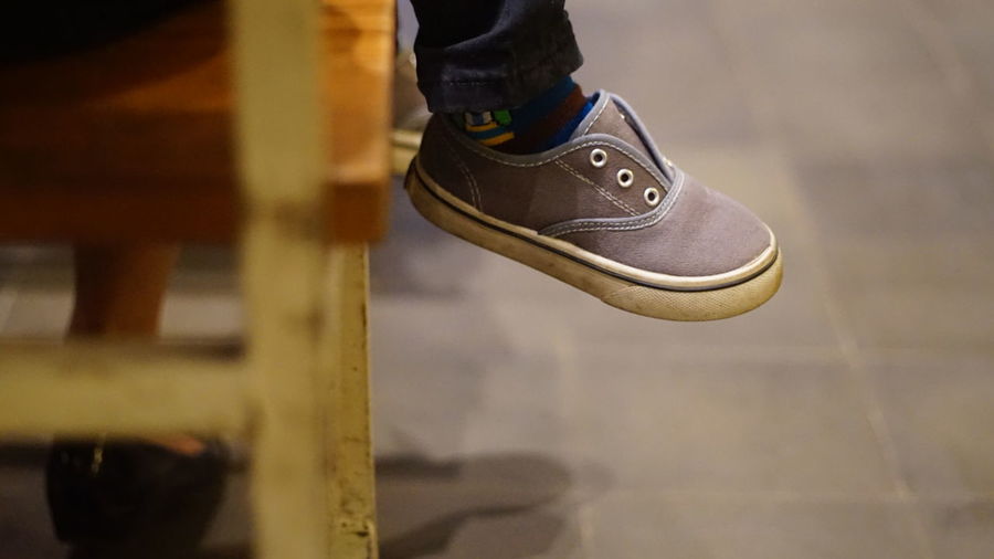 Low section of person wearing canvas shoes