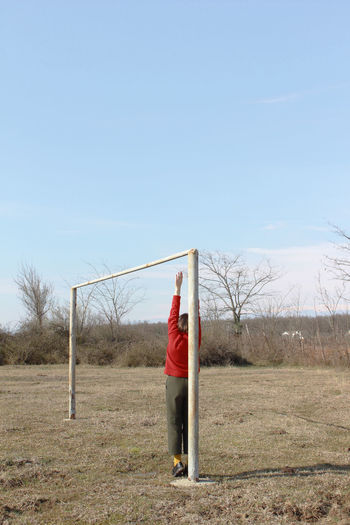 Man standing on field against clear sky